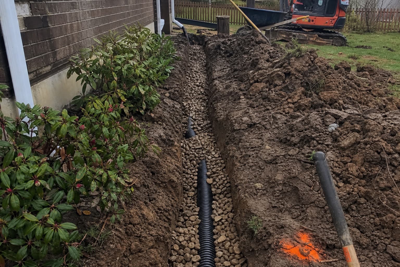 Professional french drain installation protecting a residential yard from standing water