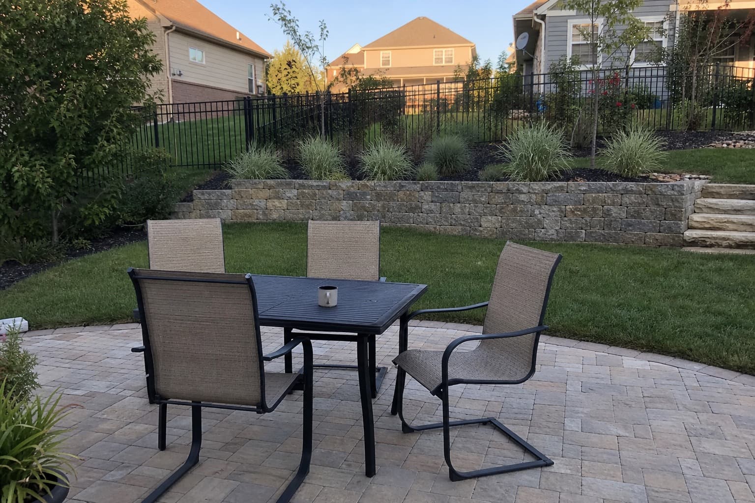 Finished paver patio with outdoor table and chairs for scale