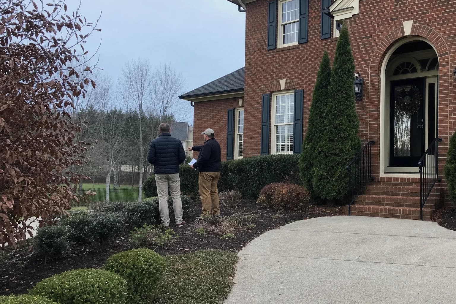 Professional landscaping contractor performing a walkthrough with a homeowner in Lexington, KY