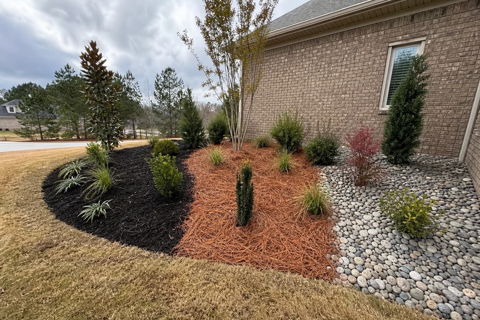 Comparison of mulch, pine straw, and river rock in residential landscape beds