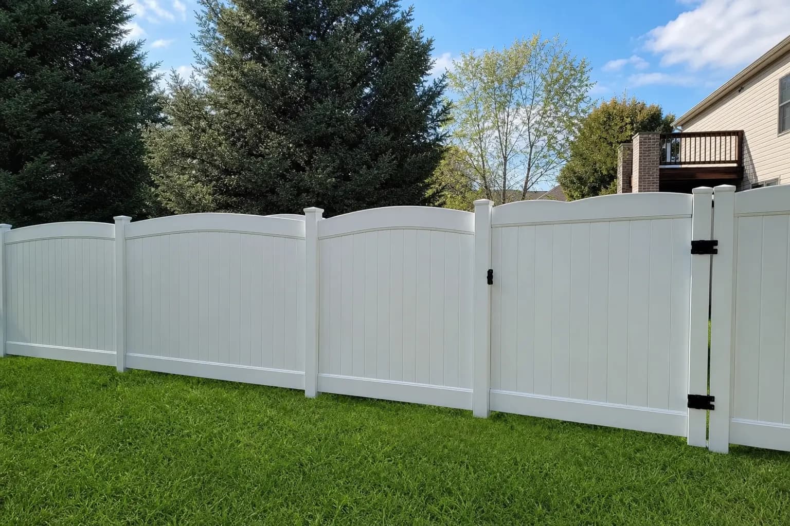 White vinyl privacy fence panels in a residential backyard
